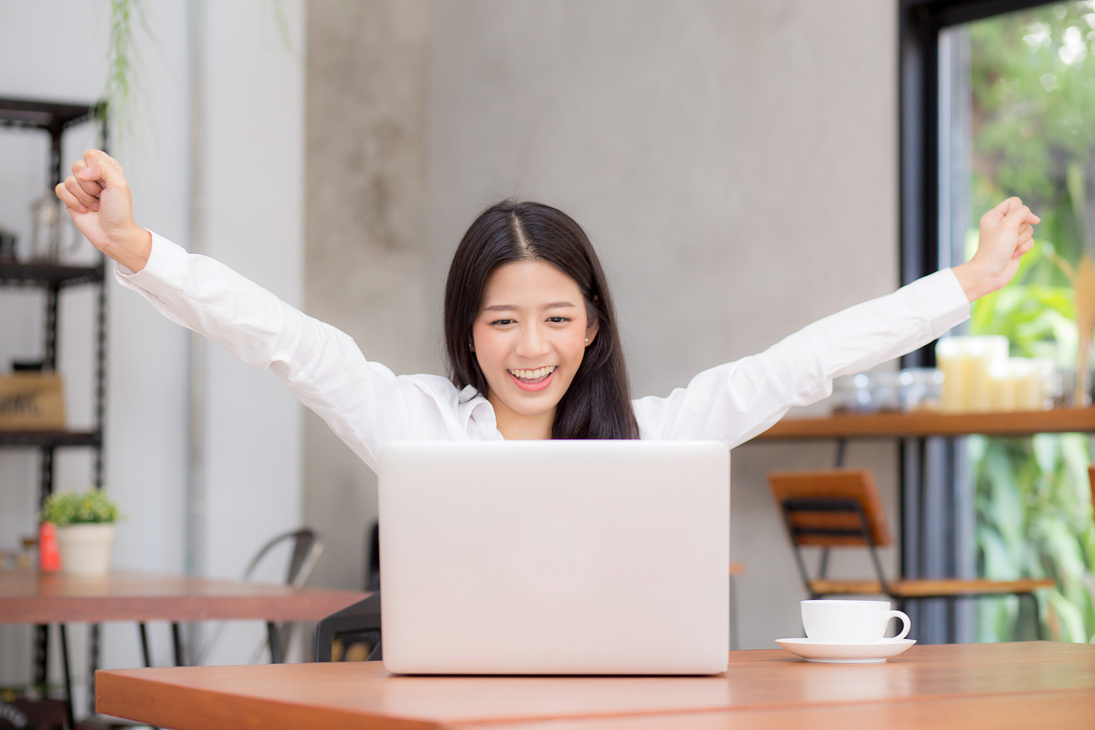 Woman Raising Arms in Sucess 